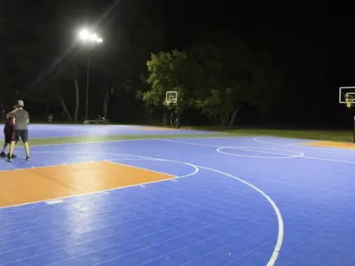 Outdoor basketball game at night