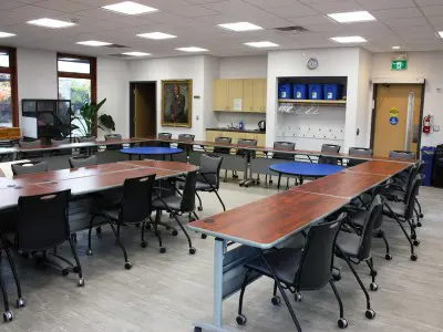 groups of tables and chairs set up in a room