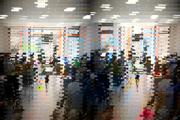 guest speaker being interviewed in front of a group of people sitting in chairs
