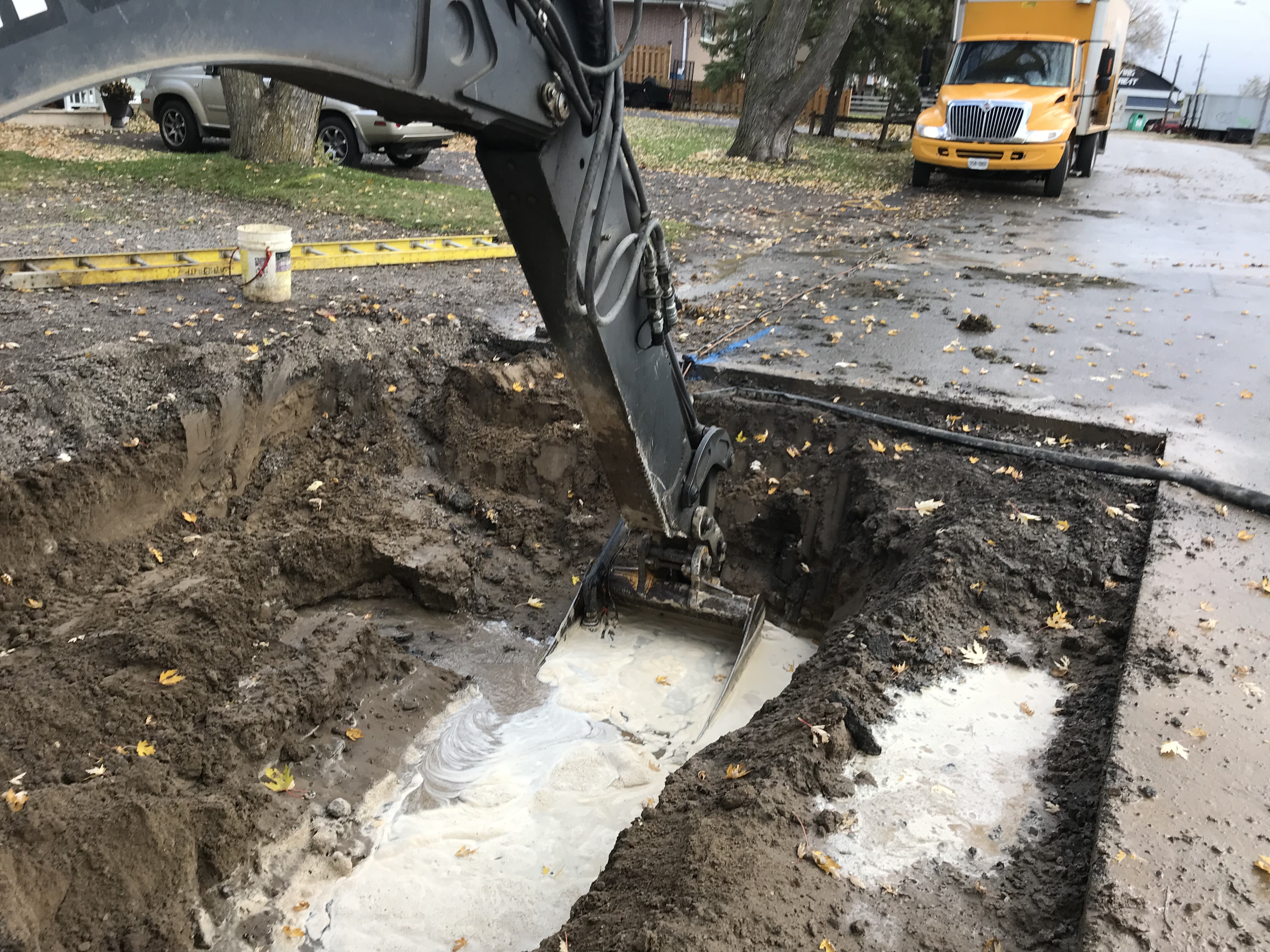 Backhoe digging underground water line