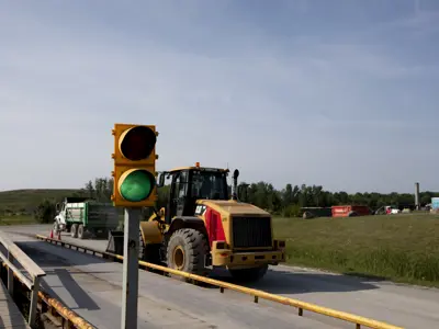 a tractor drives through loading station at the Landfill
