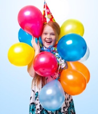 Child celebrating with balloons
