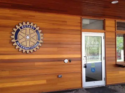 door on side of building with rotary logo on the outside wall