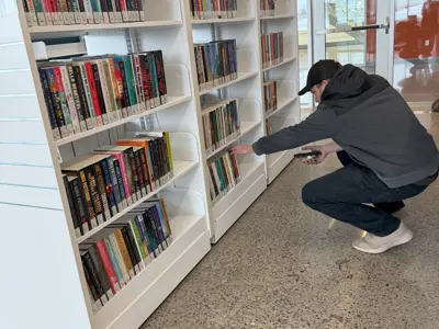 A person browses the collection at the Library branch