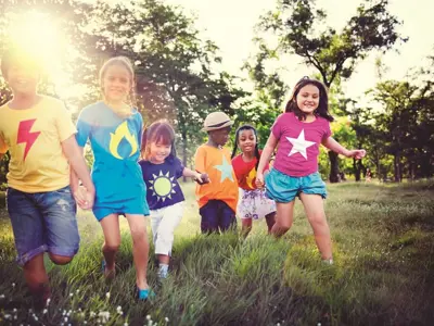 Kids running and playing in a field