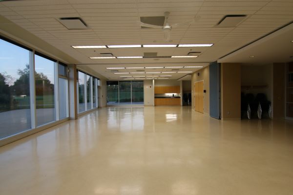 large empty multipurpose room with large windows