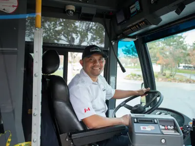 Transit driver seated at bus