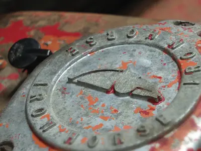 A metal medallion with a symbol and the words Iron Horse