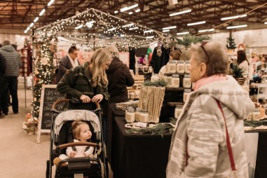 People visiting festive booths at the Modern Makers holiday market