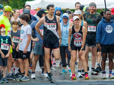 Group of runners at the starting line in wet weather