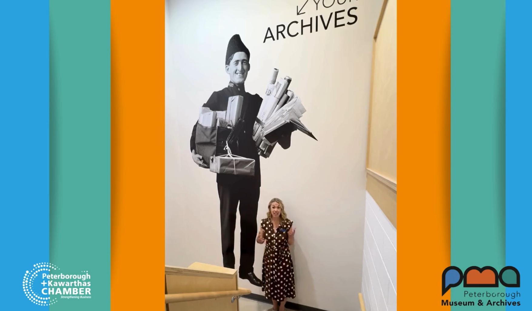 Person standing on stairs next to wall mural